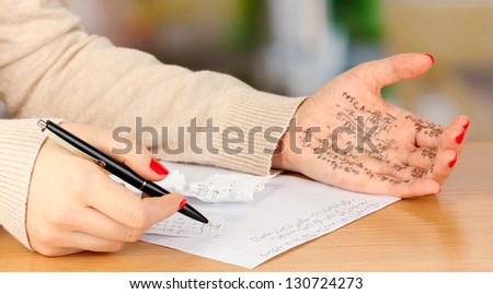 Write off exam on wooden table on room background