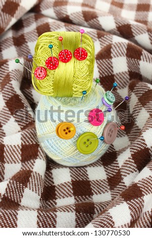 Buttons of different colors, and the two tangle thread