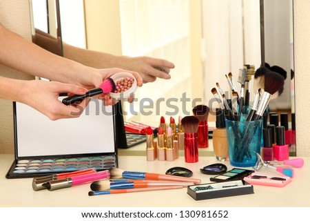 Cosmetics on table near mirrow