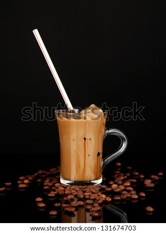 Cold coffee with ice in glass isolated on black