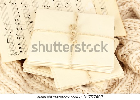 Stacks of old letters and music sheets on soft scarf
