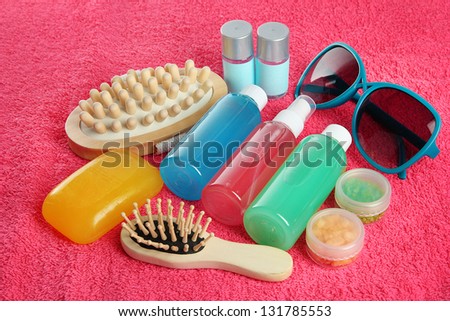 Hotel cosmetics kit on pink towel