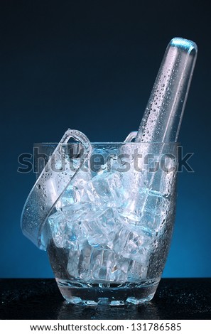 Glass ice bucket on dark blue background