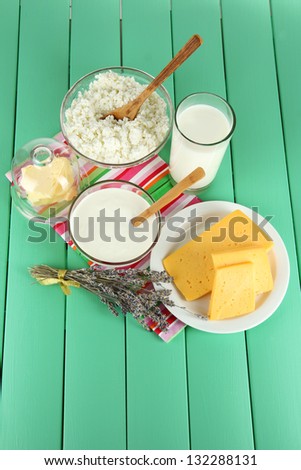 Glass of milk and cheese  on a wooden background
