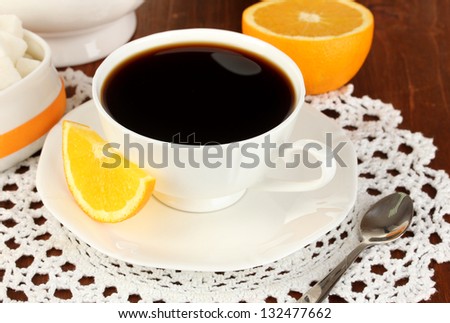Beautiful white dinner service with oranges on wooden table close-up