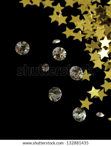Beautiful shining crystals (diamonds) and golden stars, on black background
