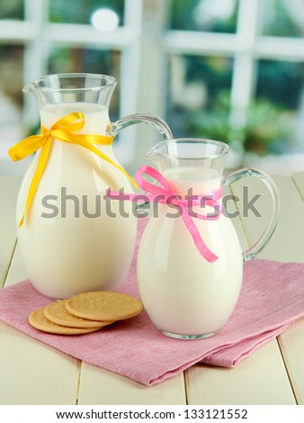 Pitchers of milk on table in room