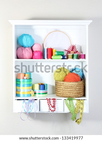 Beautiful white shelves with thread and material for handicrafts