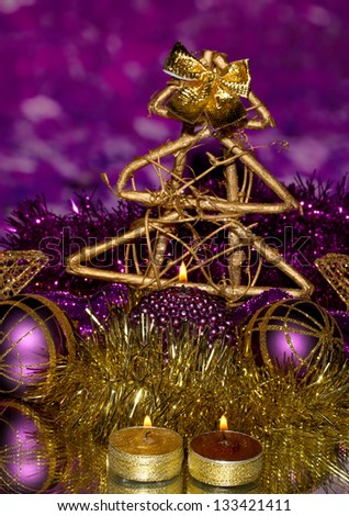 Christmas composition  with candles and decorations in purple and gold colors on bright background