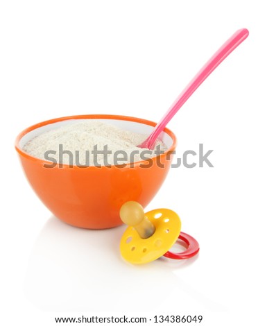 Powdered milk in bowl with spoon and nipple for baby isolated on white