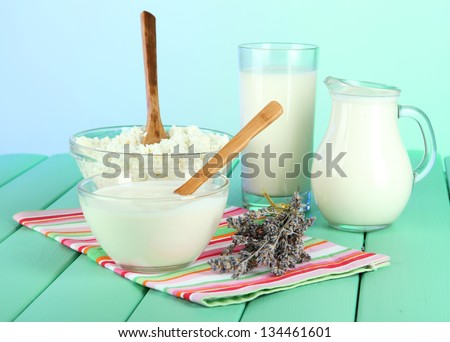 Glass of milk and cheese  on light background