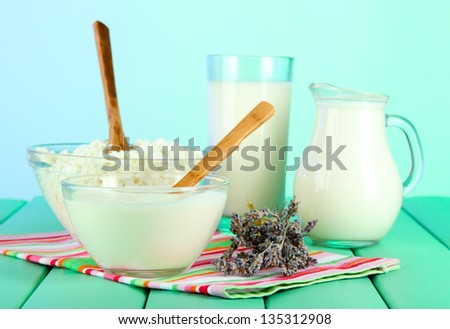 Glass of milk and cheese  on light background