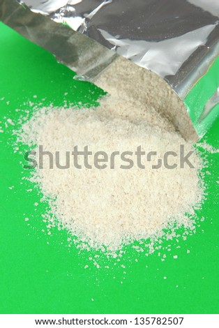 Powdered milk for baby on green background