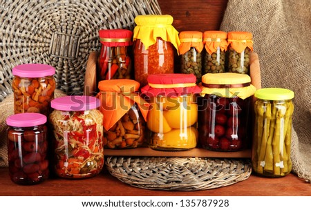 Different conservations on shelves on wooden background