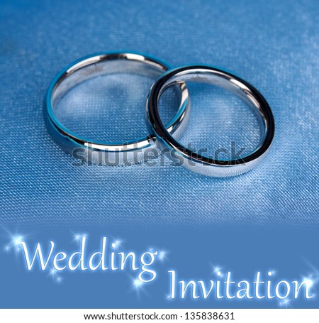 Wedding rings on satin pillow close-up