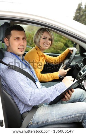 Learner driver student driving car with instructor