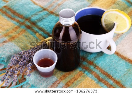 Cough syrup on knitted scarf close-up