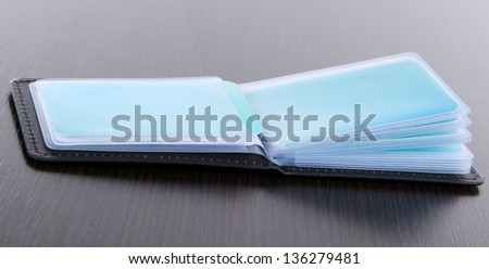 Black business card holder on dark wooden background