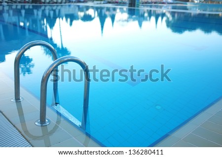 Hotel swimming pool with sunny reflections