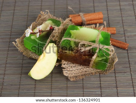 Hand made soap and ingredients for soap making on grey bamboo mat