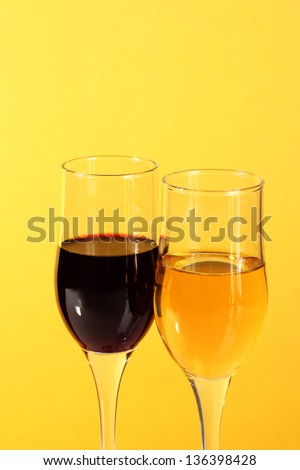 Wine in glasses  on yellow  background