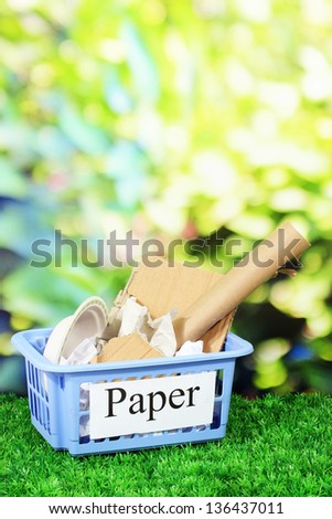Assorted trash in baskets on nature background