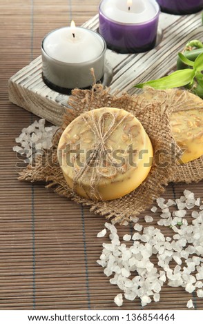 Hand-made soap and sea salt  on grey bamboo mat
