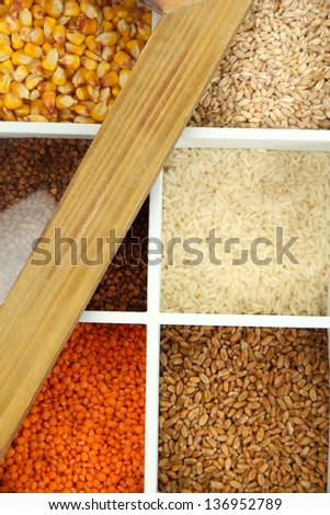 Assortment of cereals in white wooden box close up