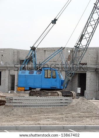 Blue lifting crane on the building object