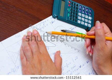 Hand with pencil drawing the graph