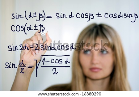 girl writing math formulas on a white-board