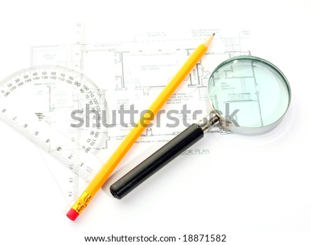 Small magnifier, protractor and pencil on the flat plan