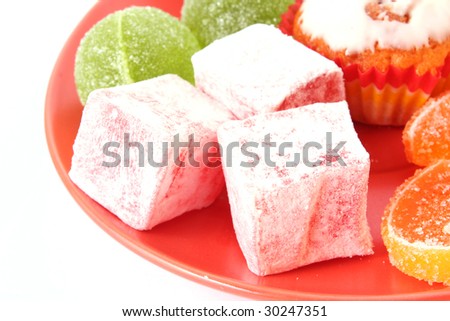 Many cakes and  Fruit jelly on plate isolated on white