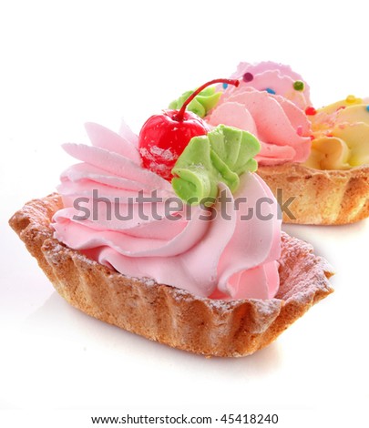 Pink cheesecake with maraschino cherry  on white