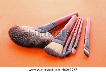 cosmetic brushes on the orange background