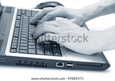 Closeup of male fingers typing a  document on the black laptop