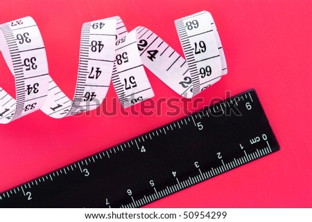 Tape measure  and ruler on yellow background