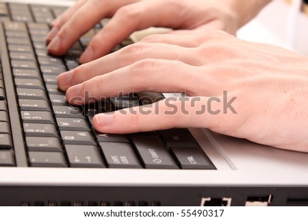 Closeup of male fingers typing a document on the black laptop