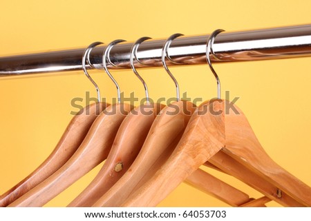 wooden coat hangers on a clothes rail