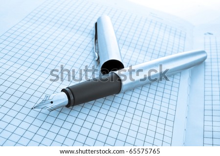 pen on notebook in blue colors