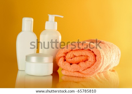 bottles of health and beauty products on yellow background