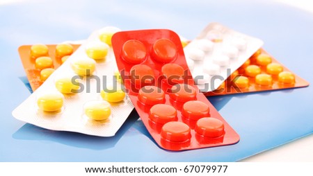 medicine pills pack pile closeup on red  background