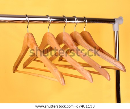 wooden coat hangers on a clothes rail