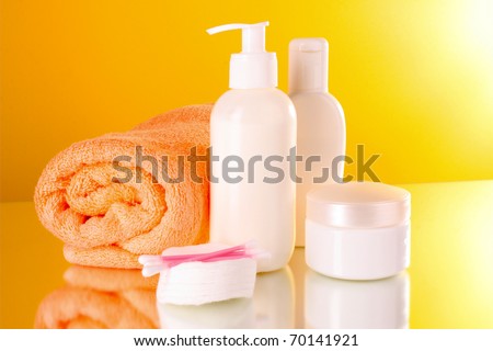 bottles of health and beauty products on yellow background