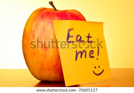 An apple on yellow background with \
