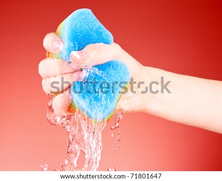 stock photo : Squeezing sponge on background