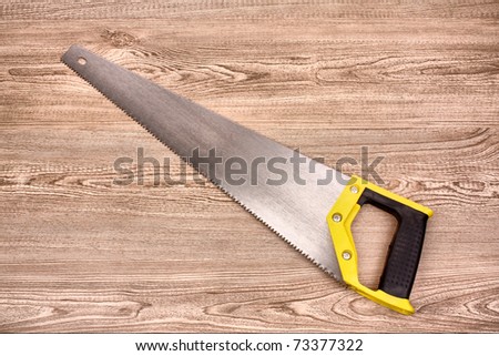 Hand saw on wooden table