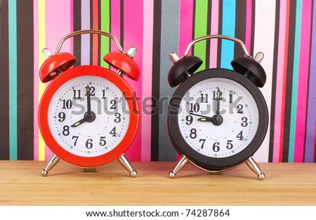 Two clocks    on  color lines background