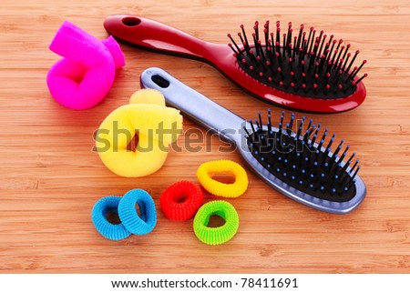 Hair Brush and hair scrunchies on brown background