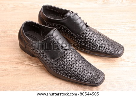 Man\'s shoes on wooden texture